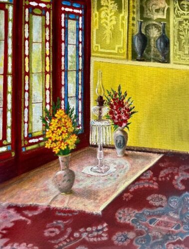 Colorful interior scene of a sunlit room with red-framed stained glass windows, yellow walls, and a patterned red carpet. Two vases of bright flowers—yellow blossoms in the foreground and red flowers behind—sit on a rug-covered floor beside an ornate glass oil lamp. Decorative wall niches and blue ceramic vases add detail to the warmly lit setting.