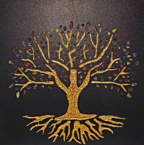 An artistic mixed-media representation of a Tree of Life set against a textured black canvas. The Tree: The central figure is a majestic tree with a thick trunk and wide-spreading branches and roots, all rendered in a textured, metallic gold finish. The texture gives it a rugged, bark-like appearance. The Foliage: Instead of leaves, the branches are adorned with a variety of small, polished gemstones in diverse colors, including shades of green, purple, blue, red, and amber. These "leaves" are scattered both on and around the golden branches. The Roots: Below the trunk, the golden roots mirror the complexity of the branches, spreading outward in sharp, organic lines. The Heart: A small, single pinkish-red gemstone is placed at the center of the trunk, serving as a focal point or "heart." Background: The entire piece is set on a dark, finely textured black background that makes the gold and colorful stones pop vividly.