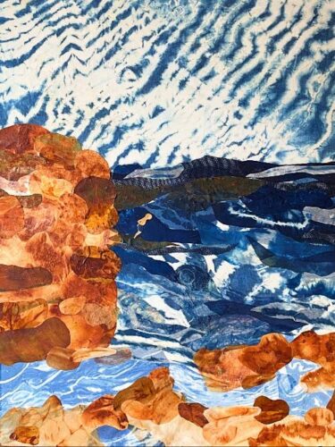 An abstract collage of Waimea Bay, created with layered fabrics and paper in shades of blue, white, and earthy ochre. On the left, a tall, vertical rock formation is composed of overlapping, rounded pieces of warm, reddish-brown and tan material. At the bottom, similar scattered rocks sit along a pale blue shoreline. The center depicts a turbulent deep blue sea with white, textured waves, where a small, minimalist figure of a person is shown mid-jump or diving from the large rock into the water. The sky fills the top half of the composition with a striking white and blue pattern, resembling rippled clouds or shibori-dyed fabric.
