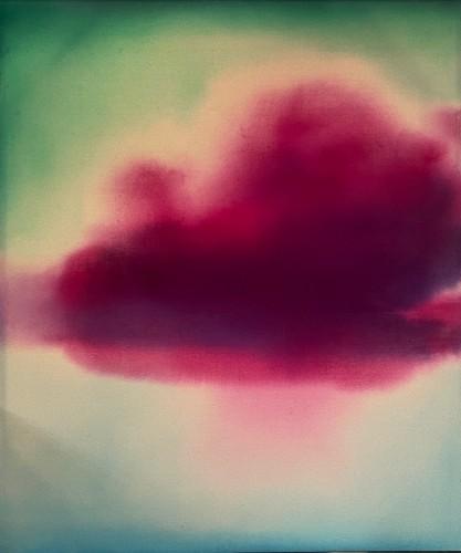 Abstract image of a deep red cloud-like form floating against a soft gradient background that fades from pale green to cream, with blurred edges and a dreamy, atmospheric appearance.