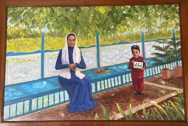 Framed painting of a woman in a blue dress and white head covering seated on a turquoise bench in a lush garden beneath a leafy tree. A young boy in a red outfit stands nearby holding a sign with calligraphy, while a small tray rests on the bench and plants and a decorative wall fill the sunny background.