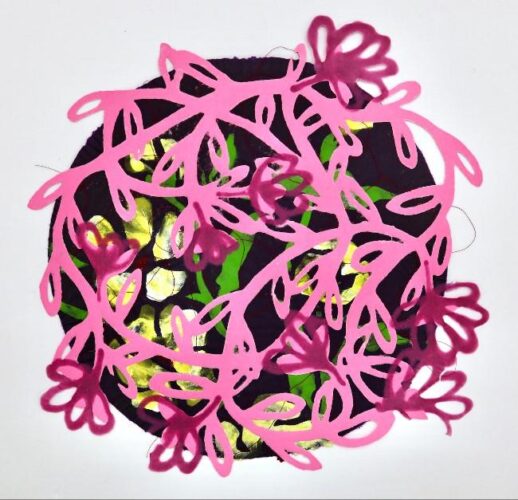 A vibrant, circular mixed-media collage centered on a plain white background. The piece combines flat, graphic paper cutouts with textured textile layers beneath. Dominating the foreground is a bright pink paper cutout of a sprawling, tangled vine with looping leaves and stylized flower buds. A darker, semi-transparent magenta color is layered onto several of the floral buds, giving them a shaded effect. This pink overlay sits atop a dark purple, circular textile base. Peeking out through the openings of the pink vine are bright, luminous patches of lime green fabric and semi-glossy, metallic yellow-gold foil or paper, creating a high-contrast, stained-glass appearance. Stray fine black threads are visible around the edges of the circular form, adding a raw, handmade texture to the artwork.