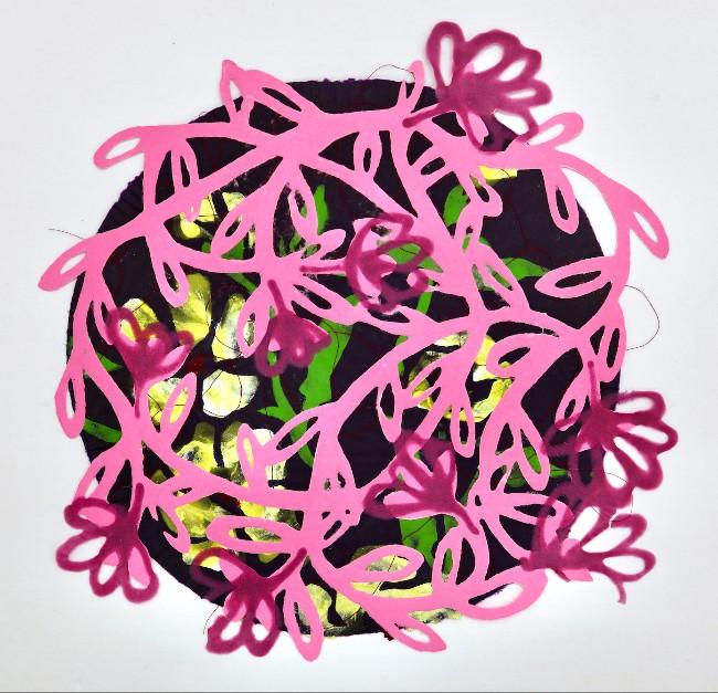 A vibrant, circular mixed-media collage centered on a plain white background. The piece combines flat, graphic paper cutouts with textured textile layers beneath. Dominating the foreground is a bright pink paper cutout of a sprawling, tangled vine with looping leaves and stylized flower buds. A darker, semi-transparent magenta color is layered onto several of the floral buds, giving them a shaded effect. This pink overlay sits atop a dark purple, circular textile base. Peeking out through the openings of the pink vine are bright, luminous patches of lime green fabric and semi-glossy, metallic yellow-gold foil or paper, creating a high-contrast, stained-glass appearance. Stray fine black threads are visible around the edges of the circular form, adding a raw, handmade texture to the artwork.